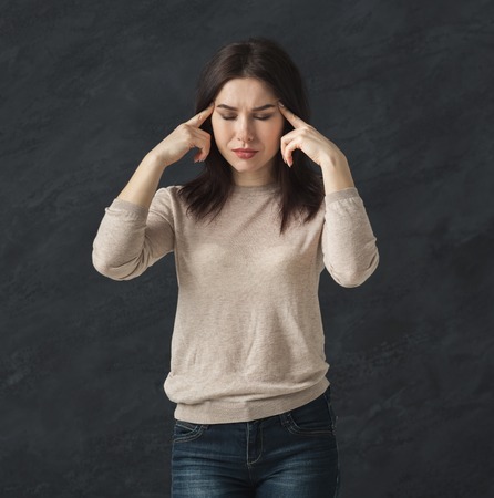 Portrait of woman having hard headache. Young girl suffering from migraine, grimacing and touching...