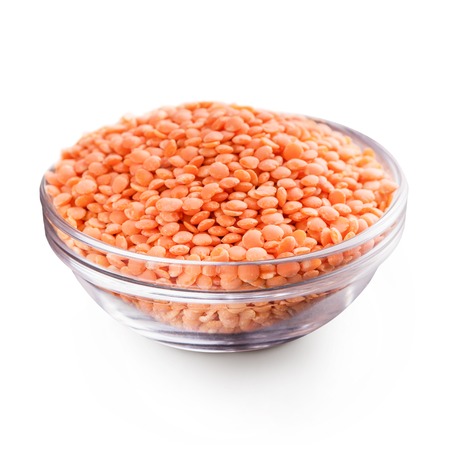 Healthy eating and dietary. Bowl of raw red lentil isolated on white backgroundの写真素材