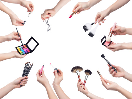 Set of makeup cosmetics in female hands isolated on white backgroundの写真素材