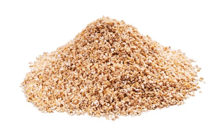 Heap of barley grits scattered on white backgroundの写真素材