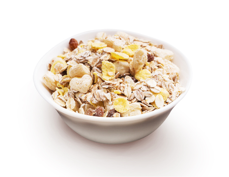 Porcelain bowl full of cereal musli isolated on white backgroundの写真素材