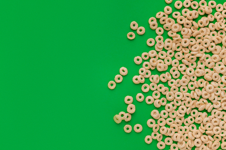 Top view of cereal rings on green background with copy spaceの写真素材