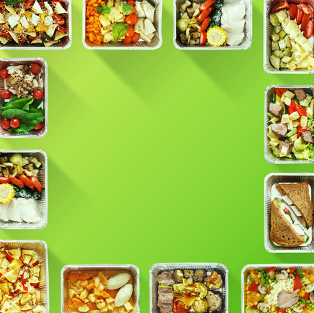 Healthy food delivery. Frame of take away boxes on green with copy space for your logo, top viewの写真素材