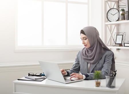 Female middle eastern office worker at her workplaceの写真素材