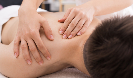 Man receiving relaxing back massage in spa centerの写真素材