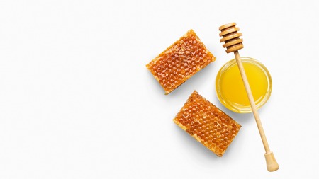 Fresh honeycombs and honey in jar with dipper, isolated on white background, top view, copy space. Natural organic ingredient posterの写真素材