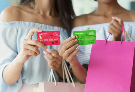 Woman with colourful bags and credit cards in shopping mallの写真素材