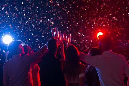 New Year party at nightclub. Crowd of friends with champagne glasses, copy spaceの写真素材