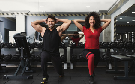 Diverse sporty couple working out in gym together, copy spaceの写真素材
