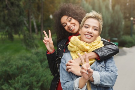 Autumn walk. Happy girls hanging out in the city, having fun