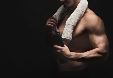 Athletic young man having rest after bodybuilding trainingの写真素材