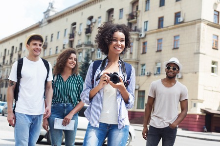 Young multiracial hipster company walking in city and taking picturesの写真素材