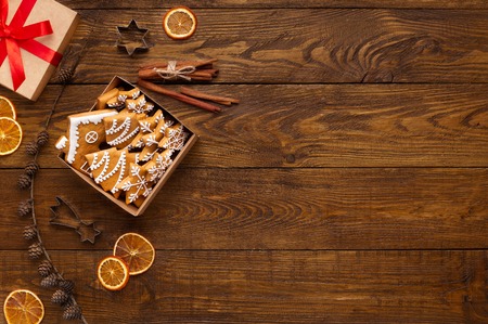 Christmas background. Gingerbread cookies in box and decorations on wooden table with copy space, top viewの写真素材