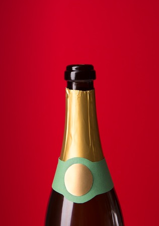 Closeup of champagne bottle on red background, top viewの写真素材