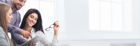 Happy business colleagues discussing new project together in office, copy spaceの写真素材