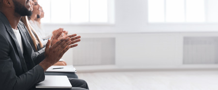 Diverse business team clapping hands during meeting, crop, copy space