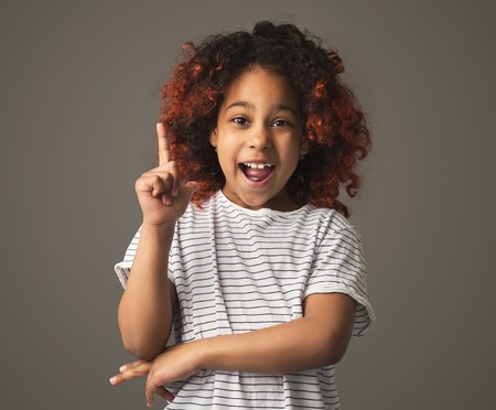 Having idea concept, afro girl making finger up gesture