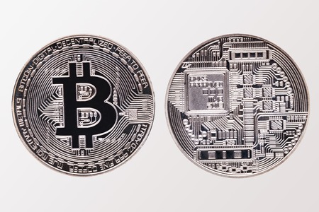 Face and back of silver Bitcoin, isolated on white backgroundの写真素材