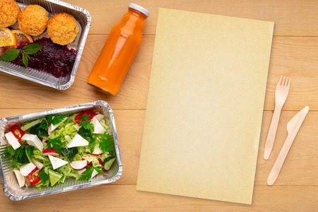 Sugar free low calorie diet. Fresh salad, healthy desser, bottle of juice, plastic cutlery and paper...