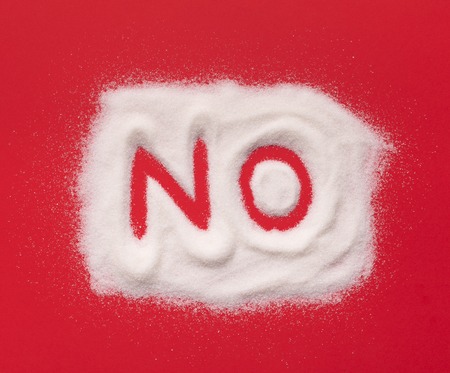 Sugar control. Word NO drawn on white pile on red background, top viewの写真素材