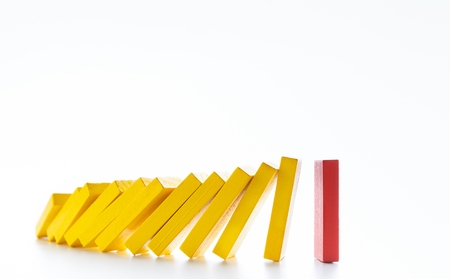 Leadership concept. Domino effect stopped by one unique strong piece, white background, panorama, copy spaceの写真素材