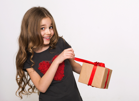 Happy girl open her gift on white background. What is inside the box concept.の写真素材
