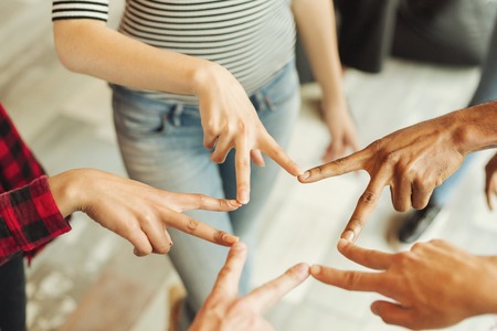 Hands forming the star shape with v-sign. International friendship concept