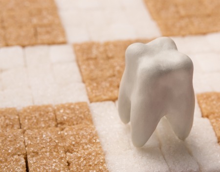 Figure of healthy tooth on chessboard made from white and cane refined sugar, copy spaceの写真素材