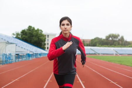 Running girl on stadium. Dont walk, run! Concept.