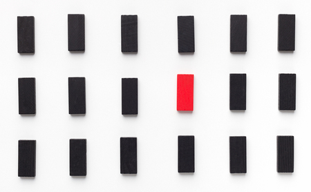Mobbing, bullying and individuality. One red wooden block between black ones, panoramaの写真素材