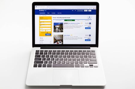 Kharkiv, Ukraine - December 11, 2018: Search results page of Booking.com web site on Macbook laptop computer screen, isolated on whiteのeditorial素材