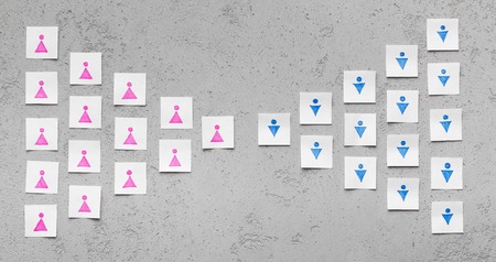 Gender wars concept. Group of women against group of men, conceptual photo with paper cards with male and female symbols, panoramaの写真素材