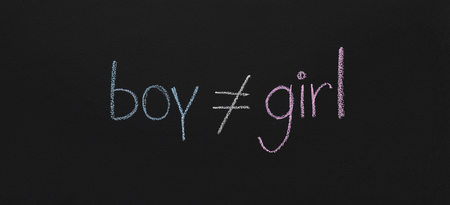 Gender inequality concept. Word Boy is not equal Girl, blue and pink chalk sketch on blackboard, panoramaの写真素材