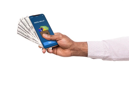 Online banking money transfer. Man holding smartphone with digital wallet application and dollar...