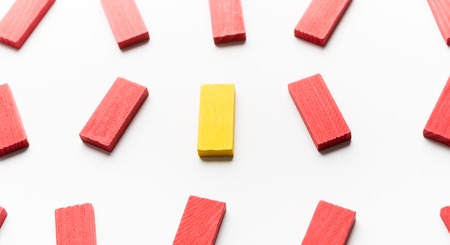 People diversity and struggle of fighting for your the right to be yourself. One yellow wooden block among red ones, panoramaの写真素材