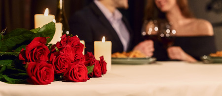Loving couple in a restaurant celebrating Valentine day. Make a reservation for Valentine celebration conceptの写真素材