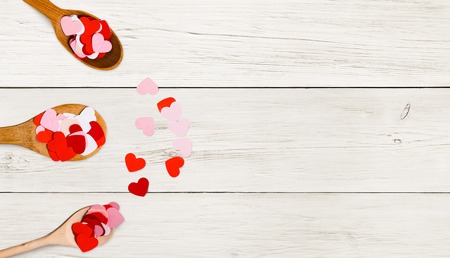 Love and Valentine Day concept. Vintage spoons with small hearts on wooden background, copy spaceの写真素材