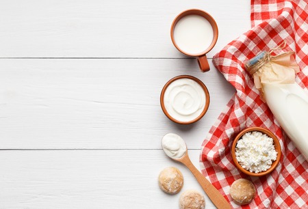 Different dairy products on white wooden background, top view, copy space, mockup. Homemade bakery recipe conceptの写真素材