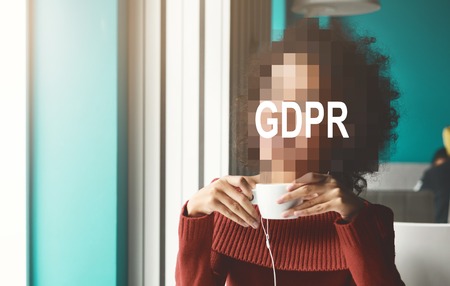 GDPR - black woman drinking coffee at cafe, her face is hidden behind the inscription General Data...
