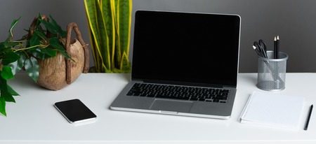 Home office with modern laptop and plants, mockup, cropの写真素材