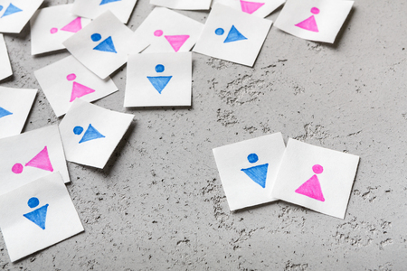 True love concept. Paper cards with male and female figures standing apart of crowdの写真素材