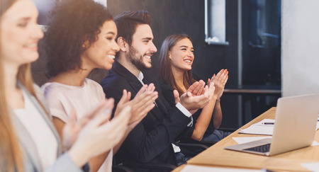 Professional education. Happy business team applauding at conference