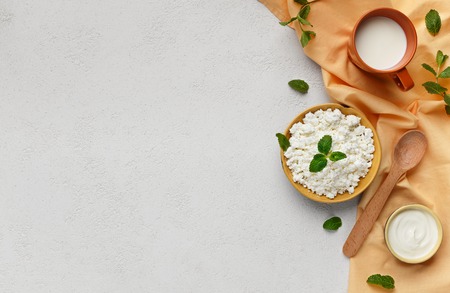 Cottage cheese, soure and cup of milk served on white background, top view, copy space. Protein diet...