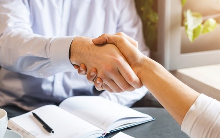 Deal. Handshake of businessmen during lunch break, came to agreement, closeup