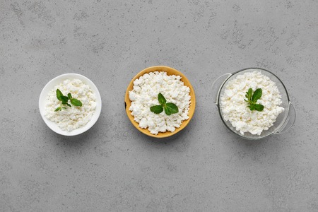 Bowls with curd on grey background, top view. Homemade curd conceptの写真素材