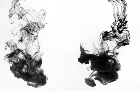 Black ink swirling in water on white background, copy space. Abstract art conceptの写真素材