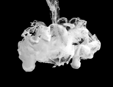 White ink swirling underwater on balack background. Abstract flowers conceptの写真素材