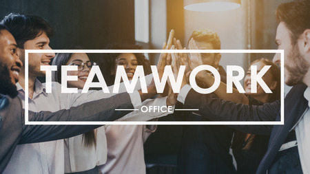 Teamwork concept. Colleagues giving high five, celebrating success in officeの写真素材