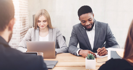 Managers working in office, using laptop and writing new ideas