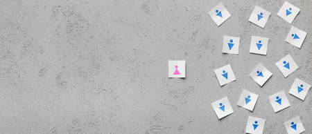 Ageism. Age discrimination shown with one paper card separate from group of others, panorama, concrete background with empty spaceの写真素材